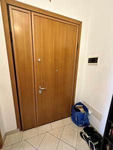 a wooden door in a room with shoes next to it at Leopardi 81 - 400 mt dall' AUTODROMO F1 in Imola