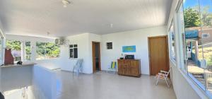 a large living room with white walls and windows at recanto provetá ILHA GRANDE in Praia de Provetá 