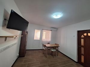 a kitchen with a table and a television in a room at L.M. in Sulina