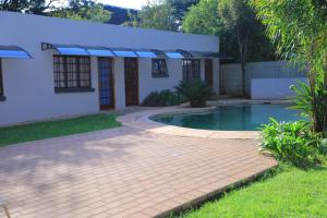 a house with a swimming pool in the yard at Ivy at 6 Peace Sleep in Pretoria