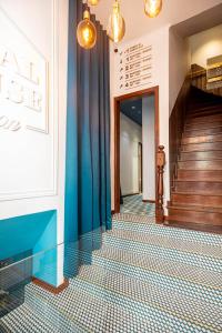 a hallway with a blue and white tiled floor at Local House Lisbon in Lisbon