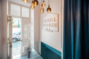 a room with a hallway with a blue floor and lights at Local House Lisbon in Lisbon