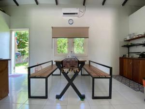 a table and two chairs in a room at Rumah Akbar Villa Taliwang in Labuanbalat