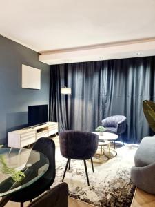 a living room with a couch and chairs and a table at On Park by Smart City Stays in Cape Town
