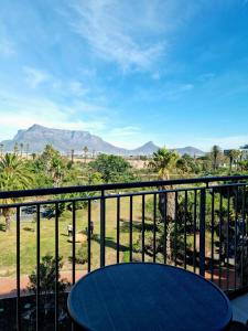 a balcony with a table and a view of the desert at On Park by Smart City Stays in Cape Town