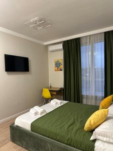 Ένα ή περισσότερα κρεβάτια σε δωμάτιο στο The Greens Apartment