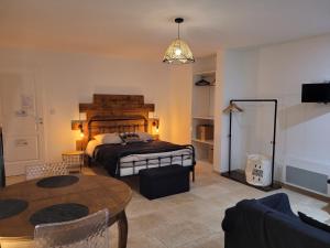 a bedroom with a large bed and a table at La Gurlanne in Lasséran