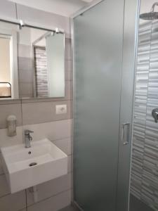 a bathroom with a sink and a shower with a mirror at Hotel Garisenda B&B - in Centro a Riccione - in Riccione +105 photos