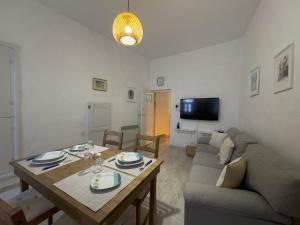 a living room with a table and a couch at yiayia's Place in Chora Folegandros