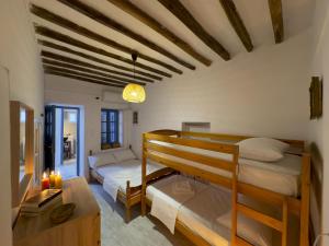 a bedroom with two bunk beds and a table at yiayia's Place in Chora Folegandros