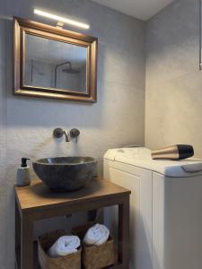 a bathroom with a bowl sink and a mirror at yiayia's Place in Chora Folegandros