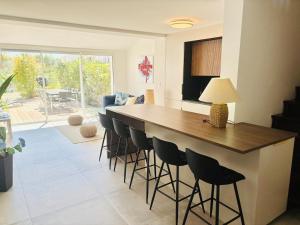 a kitchen with a large island with bar stools at Villa T4, île de la marina, parking in Cap d'Agde