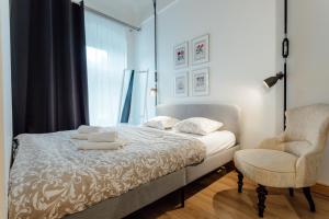 a bedroom with a bed and a chair at Apartmán CityPulse in Banská Štiavnica +10 photos