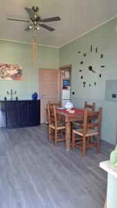 a dining room with a table and chairs and a clock at I SOGNI di LEO 2 in Turin