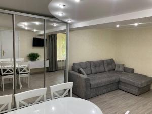 a living room with a couch and a table at VEL-Шевченка in Chernivtsi