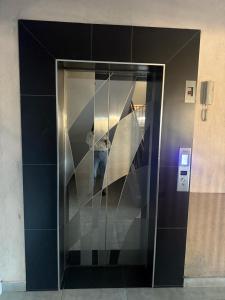 a glass elevator with a staircase in a building at Studio Apartment - The Aviv Kitisuru near KSG in Nairobi