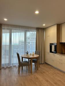 a kitchen and dining room with a table and chairs at Skyline studio 44 in Varna City