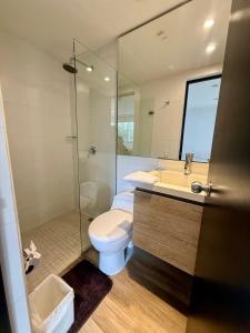 a bathroom with a toilet and a sink and a shower at Beautiful Apto in Poblado in Medellín +12 photos