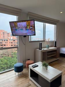 a living room with a flat screen tv on the wall at Beautiful Apto in Poblado in Medellín