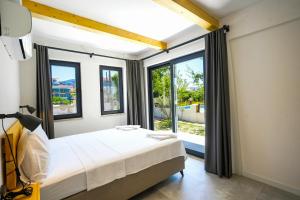 a bedroom with a bed and a large window at Meva Luxury Apartments in Muğla +14 photos