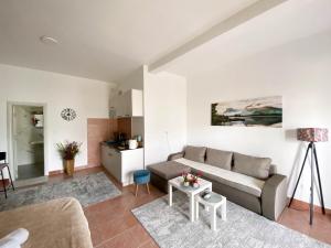 a living room with a couch and a table at Olive apartment in Podgorica