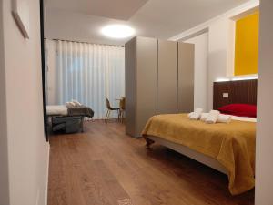 a bedroom with a large bed and a room with a bedictericter at CconfortHotels Suite 104 in Bari