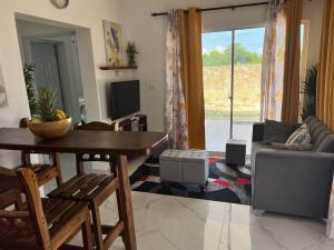 a living room with a table and a couch at Residencia Bambou HAVRE DE PAIX in Juan Dolio