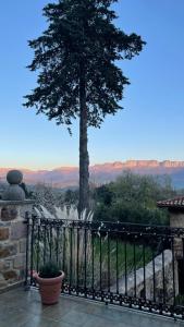 a fence with a tree and mountains in the background at Casa Mi Capricho in Concejero +45 photos