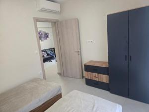 a bedroom with two beds and a closet and a mirror at Stella Apartment in Nikiti
