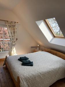 a bedroom with a bed and a large window at Mer et Campagne, maison entourée d'un jardin privé in Quend