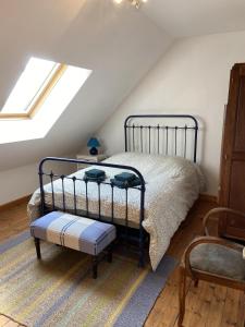 a bedroom with a bed in a attic at Mer et Campagne, maison entourée d'un jardin privé in Quend