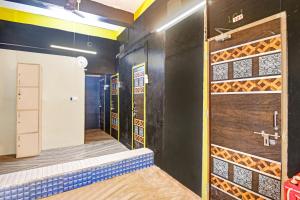 a room with a walk in shower and a door at Hotel O Mo Kudia in Brahmapur