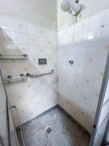 a bathroom with a shower with a glass door at Solar Lages - Diamantina - MG in Diamantina +44 photos