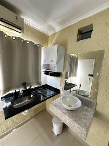 a bathroom with two sinks and a counter top at RiverSide 101 in Petrolina