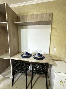 a small table with two plates on it in a room at RiverSide 101 in Petrolina