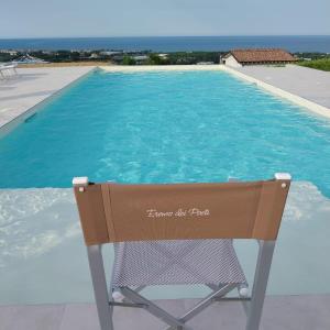 a chair sitting in front of a swimming pool at Eremo Dei Poeti in Mosciano SantʼAngelo