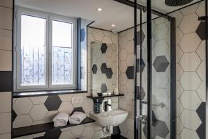 a bathroom with a sink and a shower at Hotel Atlantique in Le Palais