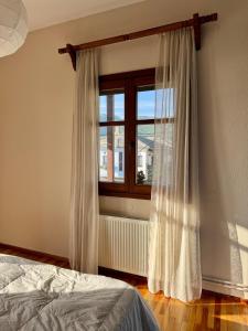 a bedroom with a bed and a window at Patrikon in Zagora +15 photos