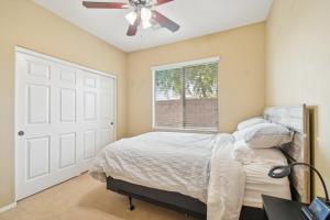 a bedroom with a bed and a ceiling fan at Gilbert Getaway in Gilbert +26 photos