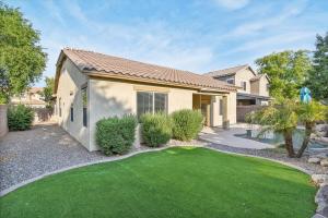 a house with a green lawn in front of it at Gilbert Getaway in Gilbert
