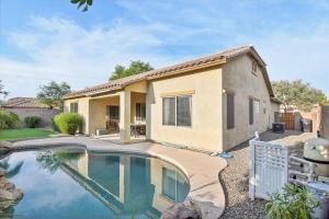 a house with a swimming pool in front of it at Gilbert Getaway in Gilbert