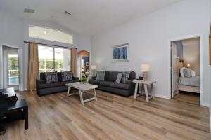 a living room with a couch and a table at Quiet Getaway Nr Golf & Posner Park with Pool in Davenport