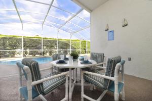 a dining room with a table and chairs and a pool at Quiet Getaway Nr Golf & Posner Park with Pool in Davenport
