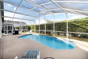 a swimming pool with a glass roof at Quiet Getaway Nr Golf & Posner Park with Pool in Davenport
