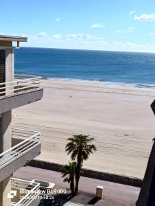 a view of the beach from the balcony of a condo at T2 Vue latérale Mer 1 Ligne clim in Canet-en-Roussillon