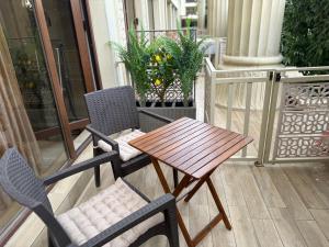 a wooden table and chairs on a balcony at Argisht STUDIO 602 in Golden Sands