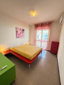 a bedroom with a bed and a window at Residence Luna in Lignano Sabbiadoro