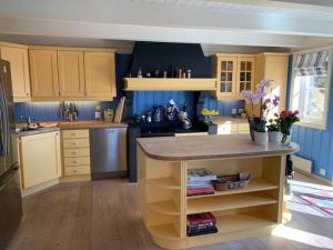 a kitchen with a island in the middle of it at Seaside Villa in Sandefjord