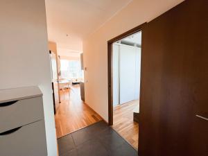 a hallway with a door leading to a living room at Panoramic Sea View -13th Floor in Tallinn +3 photos