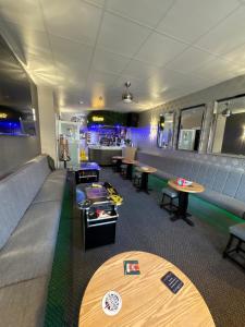 a restaurant with tables and chairs and a bar at Clifton Private Hotel in Blackpool